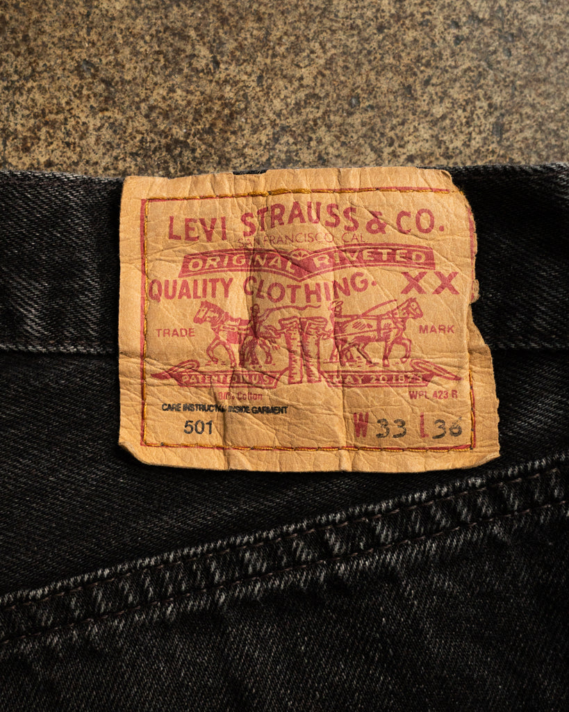 Levi's 501 Faded Black Patched Jeans - 1990s back patch detail
