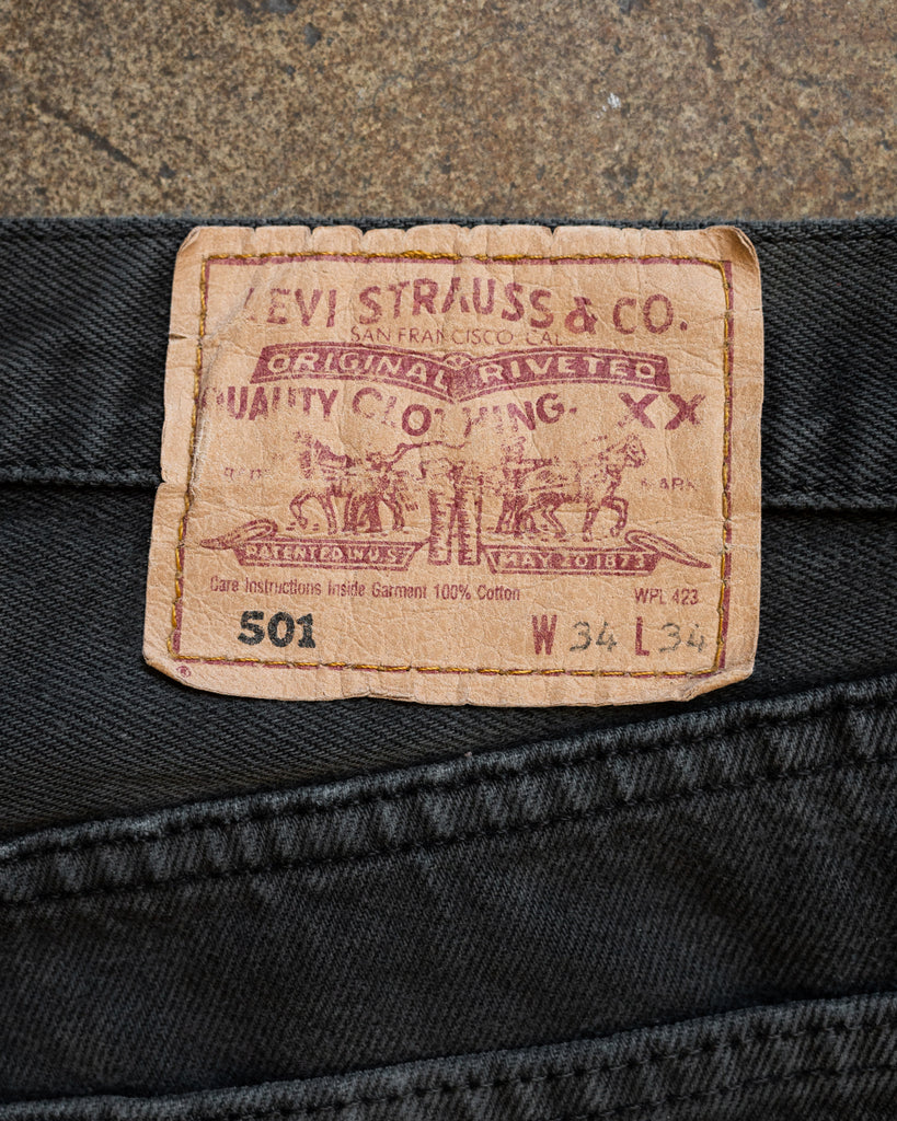 Levi's 501 Faded Black Repaired Released Hem Jeans - 1990s detail patch photo